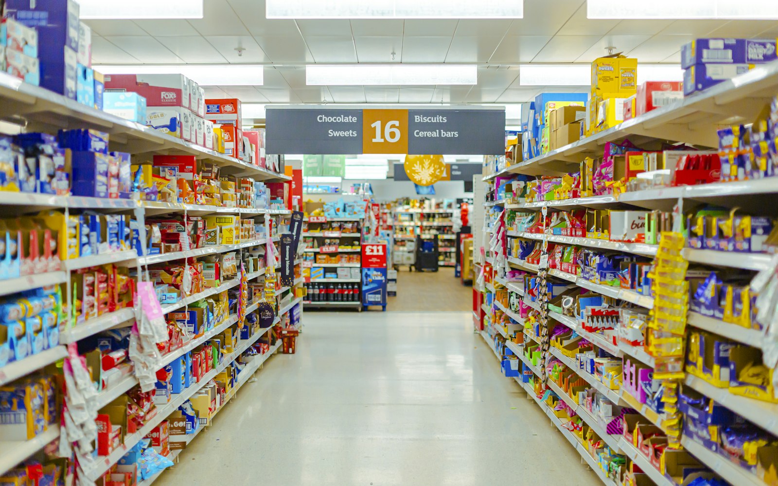 A large, fully stocked grocery store aisle